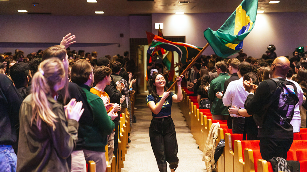A Moody student carries the Brazilian flag during the flag procession that opened Missions Conference 2024 